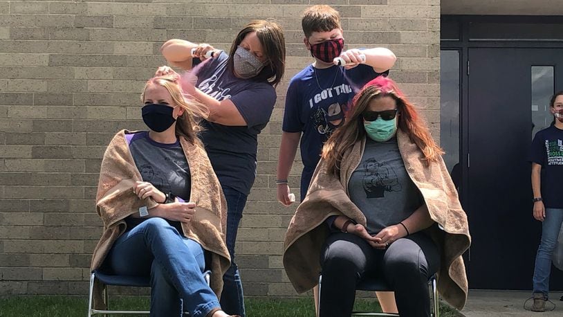 Talawanda Middle School students rallied recently through a hair-dyeing fundraiser to help a teacher who learned she had breast cancer just before Christmas. Students and staffers donated money - nearly $1,300 - to have their hair dyed pink in honor of the international color of breast cancer awareness. (Provided Photo\Journal-News)