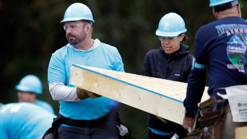 Country music star Garth Brooks, left, works at a Habitat for Humanity building project Monday, Oct. 7, 2019, in Nashville, Tenn.