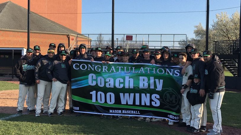Mason’s baseball team celebrates head coach Curt Bly’s 100th career victory Tuesday after the Comets blanked visiting Hamilton 5-0. RICK CASSANO/STAFF