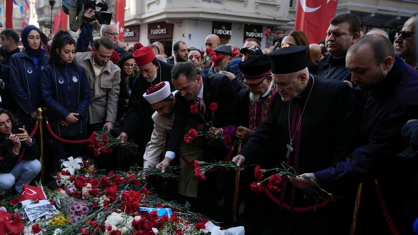 FILE - Representatives of the Turkish communities put flowers over a memorial placed on the spot of Sunday's explosion on Istanbul's popular pedestrian Istiklal Avenue in Istanbul, Turkey, Wednesday, Nov. 16, 2022. Alham Albashir, alleged bomber of a deadly blast killing six and injuring 99, received 7 consecutive life sentences by an Istanbul court on Friday, April 26, 2024, Turkey’s state-run news agency reported. (AP Photo/Khalil Hamra, File)