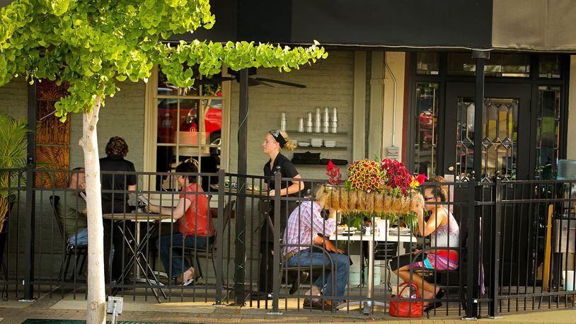 Outdoor dining at the Caroline restaurant in downtown Troy provides a view of the fountain and activity on the square. JIM WITMER / STAFF