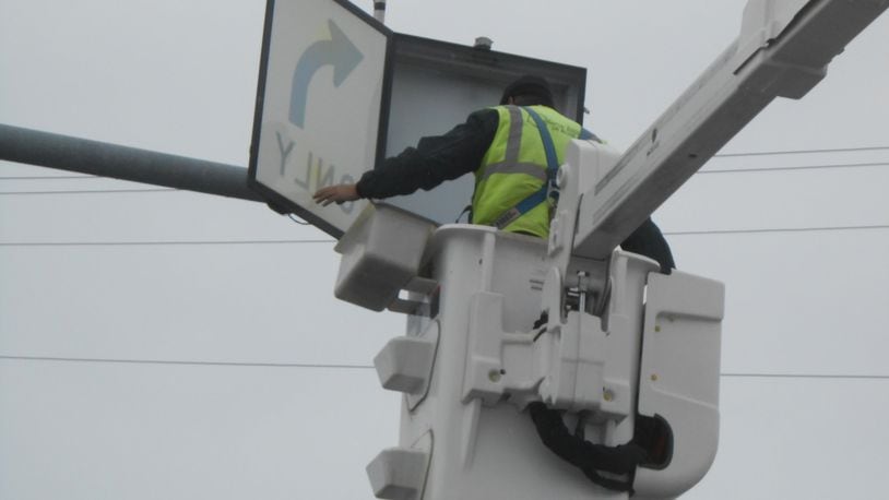 The city of Fairfield is about half way complete with its city-wide traffic signal upgrades, which includes doing something at nearly all of its 61 signaled intersections. That includes upgrading push buttons, adding back plates or new LEDs for street signs. Pictured is a contractor working on a signal at Ohio 4.