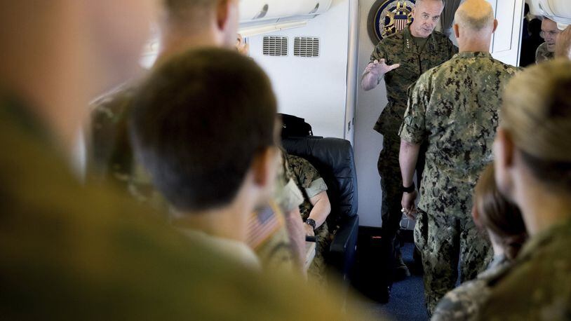 Joint Chiefs Chairman Gen. Joseph Dunford speaks to members of his staff aboard his plane as it departs Fort Greely, Alaska, Saturday, Aug. 19, 2017, to travel to Andrews Air Force Base, Md. President Donald Trump is “studying and considering his options” for a new approach to Afghanistan and the broader South Asia region, the White House said Friday. Gen. Joseph Votel, the Central Command chief who is responsible for U.S. military operations in the greater Middle East, including Afghanistan said that Defense Secretary Jim Mattis and Dunford represent him in the White House-led Afghanistan strategy review. (AP Photo/Andrew Harnik)