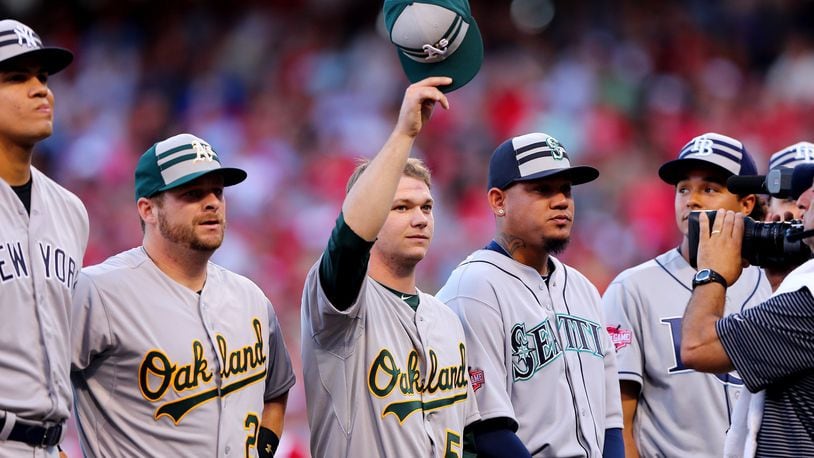 Oakland Athletics pitcher Sonny Gray, center, waves to the crowd prior to the 86th MLB All-Star Game at the Great American Ball Park on July 14, 2015 in Cincinnati, Ohio. (Photo by Elsa/Getty Images)
