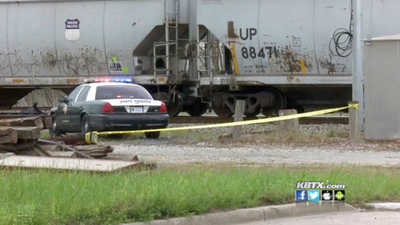 Authorities investigate the scene after a 19-year-old was struck by a train in Navasota, Texas.