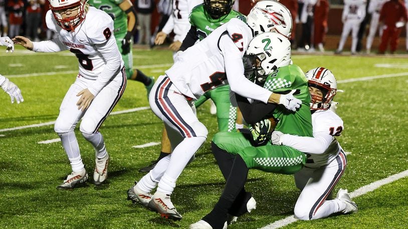 Badin's Connor Wright is tackled by Tippecanoe's Lukas Walker (47) and Ethan Henderson (12) during a 20-17 loss to Tippecanoe in their Division III Regional Final football game Friday, Nov. 18, 2022 at Trotwood-Madison High School. NICK GRAHAM/STAFF