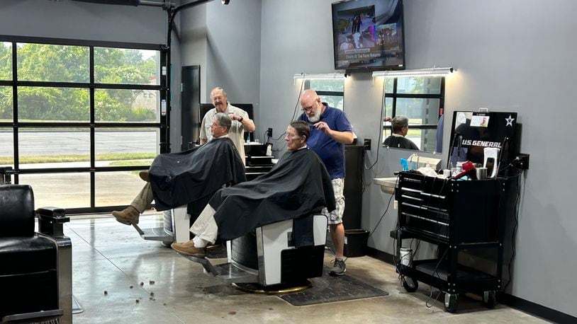 Hamilton West Barber Shop, 186 N. Brookwood Ave., was voted Butler County's best barber shop by Journal-News readers. The barber shop moved into a converted gas station/car wash four years ago and has seen plenty of changes over the years. Here, Steve Mallicote, 74, and Ryan Haynes, 48, the owner, cut hair while talking to their customers. RICK McCRABB/STAFF