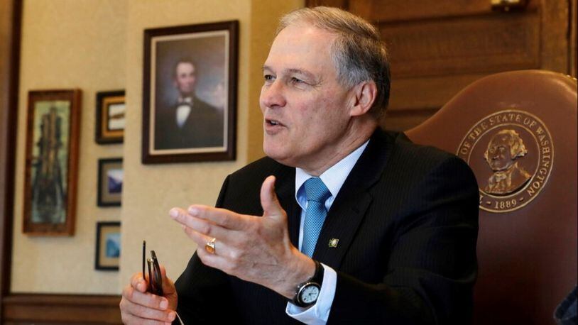 Washington Gov. Jay Inslee speaks during a morning meeting with staff members in his office, Wednesday, Feb. 27, 2019, at the Capitol in Olympia, Wash. (AP Photo/Ted S. Warren)