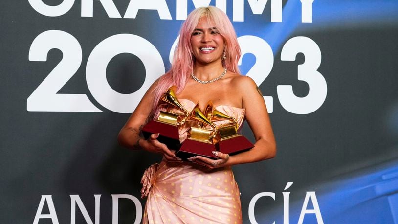 Karol G poses with the awards for best urban album for "Mañana Sera Bonito", for album of the year for "Mañana Sera Bonito" and the award for best urban fusion/performance for "TQG" during the 24th annual Latin Grammy Awards in Seville, Spain, Thursday, Nov. 16, 2023. The 2024 Latin Grammys will return to Miami — where the show first started 25 years ago, and where the organization is headquartered. (Photo by Jose Breton/Invision/AP, File)