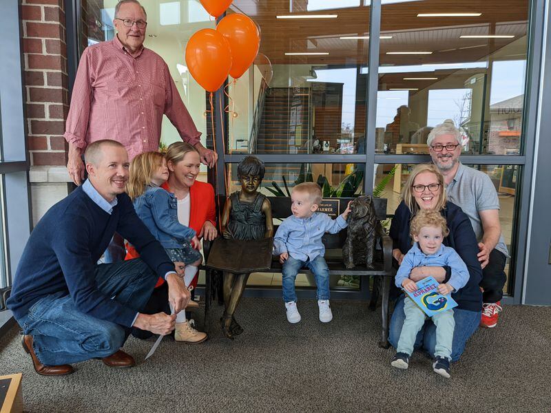 Members of the late Shari Farmer's family gathered for the dedication of a bench at Oxford Lane Library last Sunday placed in the vestibule in her memory.  CONTRIBUTED