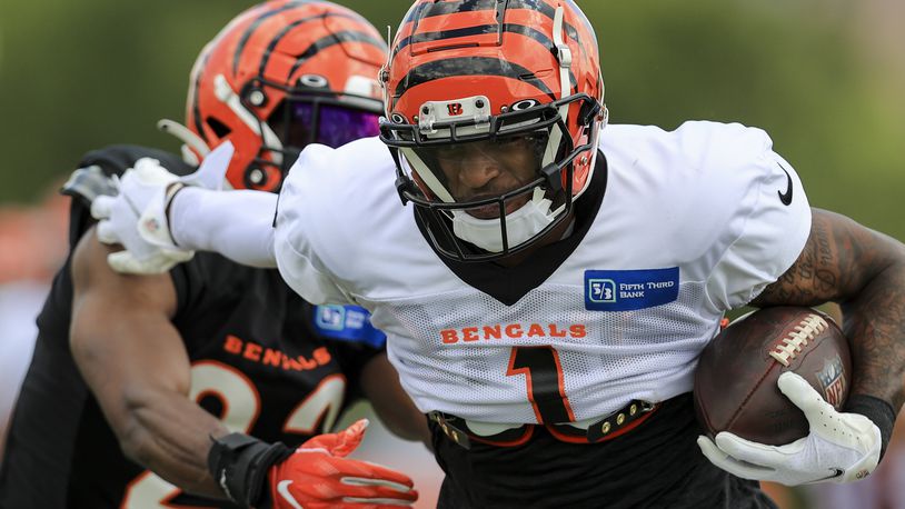 Cincinnati Bengals' Ja'Marr Chase (1) makes a catch against Chidobe Awuzie in a drill during an NFL football practice in Cincinnati, Tuesday, Aug. 3, 2021. (AP Photo/Aaron Doster)
