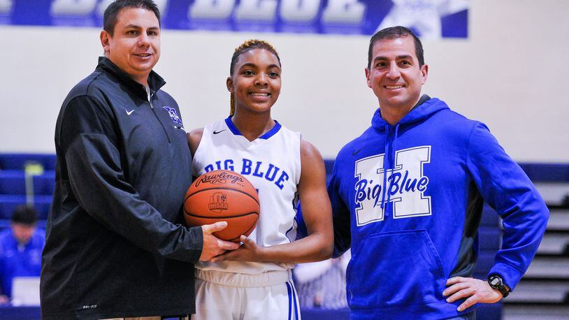 Hamilton’s CiCi Riggins (middle) stands with Hamilton athletic director Todd Grimm (left) and principal John Wilhelm to be honored as the school’s all-time leading scorer in girls basketball during Thursday night’s game against Northwest at the Hamilton Freshman School. The visiting Knights won 62-51. NICK GRAHAM/STAFF