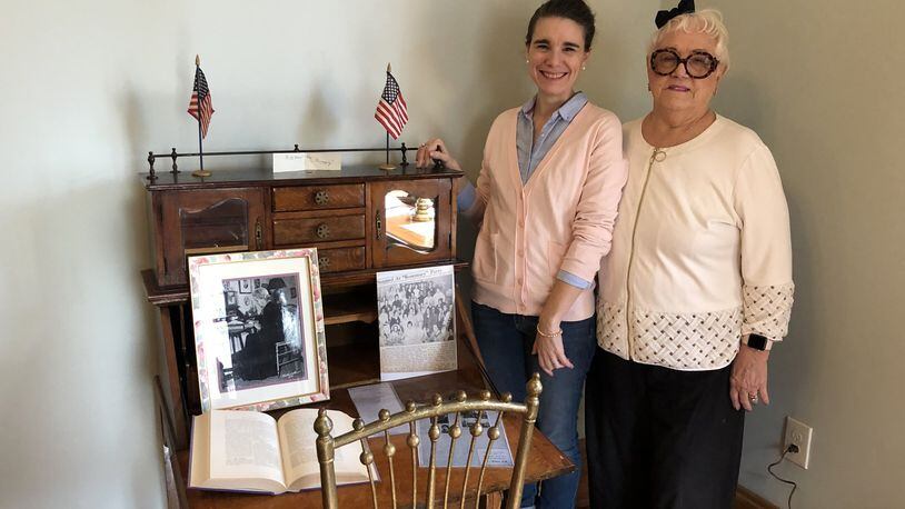 Carrie Halim, left, and Kathleen Stuckey Fox stand next to a desk once used by early-20th century Journal-News columnist Stella Weiler Taylor, whose photograph as an older woman sits on the desk. They are in a new history room at The Father’s House, which is on the D Street property of the former Butler County Children’s Home. MIKE RUTLEDGE/STAFF