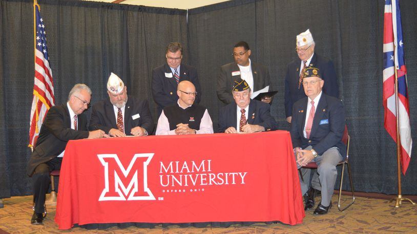 Miami President Gregory Crawford (seated center) and Buckeye Boys State Director Jerry White (right of Crawford) were among signers of the contract bringing the annual program to Miami University’s Oxford campus starting next June. CONTRIBUTED/BOB RATTERMAN