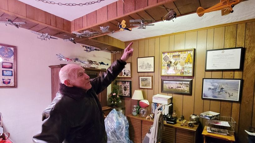 Barney Landry shows off models of all the airplanes he has flown at his Hamilton home. Landry graduated from West Point and was a pilot in the Air Force who flew into radioactive clouds to collect data during nuclear testing in Marshall Islands. He then became an engineer at General Electric. NICK GRAHAM / STAFF