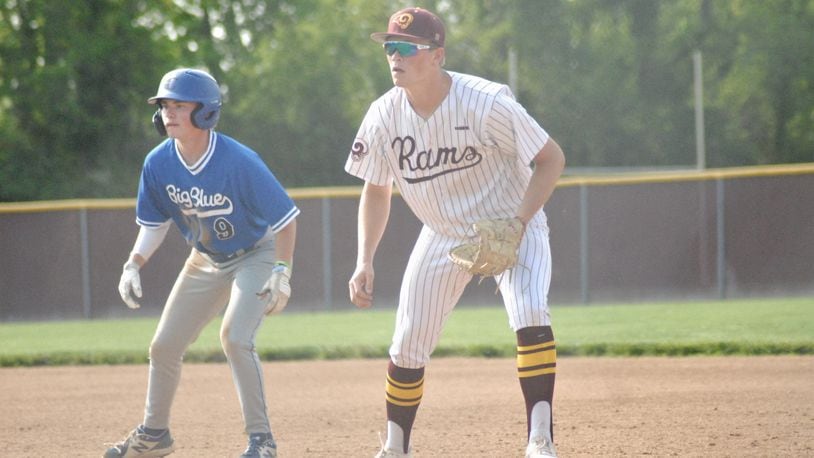 Hamilton base runner Nick Brosius and Ross first baseman Nathan Bray eye a pitch at the plate during their Division I sectional game on Wednesday. Big Blue won 1-0 in eight innings. Chris Vogt/CONTRIBUTED