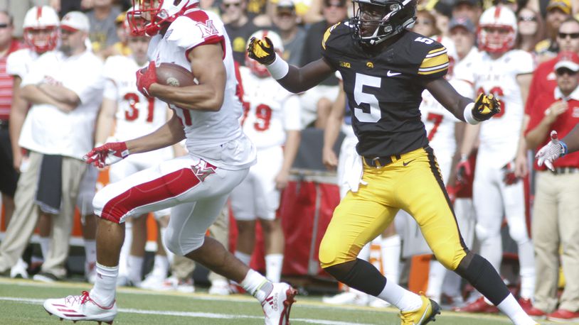 IOWA CITY, IOWA- SEPTEMBER 3: Running back Maurice Thomas #31 of the Miami (OH) RedHawks breaks a tackle by defensive back Manny Rugamba #5 of the Iowa Hawkeyes during the second quarter on September 3, 2016 at Kinnick Stadium in Iowa City, Iowa. (Photo by Matthew Holst/Getty Images)
