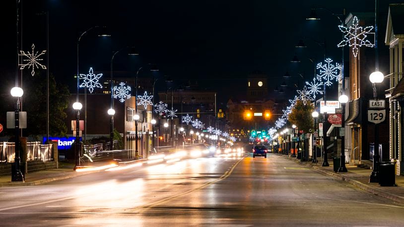 Holiday snowflake lights have been placed and illuminated on the light poles along Main Street in Hamilton Wednesday, Nov. 3, 2021. NICK GRAHAM / STAFF