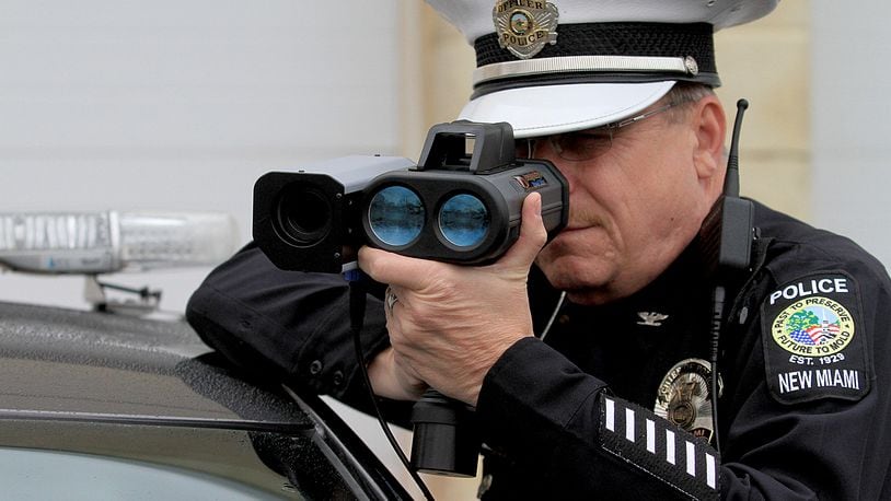 New Miami Police Chief Dan Gilbert demonstrates Monday, Dec. 21, 2015, the new hand held speed cameras. CONTRIBUTED/E.L. HUBBARD