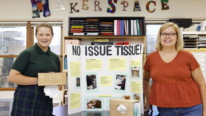 Ann Marie Davis, 12, won a state design award for her "No Issue Tissue" designed to make it easier for people with mobility issues to grab a tissue while in bed. The Queen of Peace student came up with the idea and created the project for her makerspace class taught by Melissa Moser,  right. NICK GRAHAM/STAFF