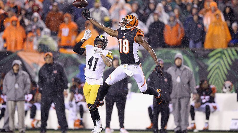 CINCINNATI, OH - JANUARY 09: A.J. Green #18 of the Cincinnati Benglas reaches up to catch a pass against the Pittsburgh Steelers at Paul Brown Stadium on January 9, 2016 in Cincinnati, Ohio. (Photo by Andy Lyons/Getty Images)
