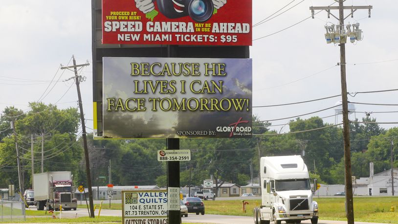 A billboard previously warned motorists of the speed cameras set up in New Miami. STAFF FILE PHOTO/2013