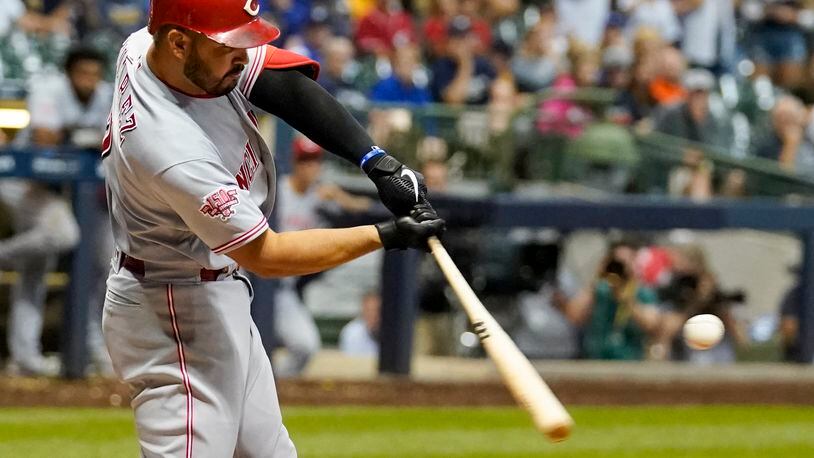 Cincinnati Reds' Eugenio Suarez hits a two-run home run during the ninth inning of a baseball game against the Milwaukee Brewers Monday, July 22, 2019, in Milwaukee. (AP Photo/Morry Gash)