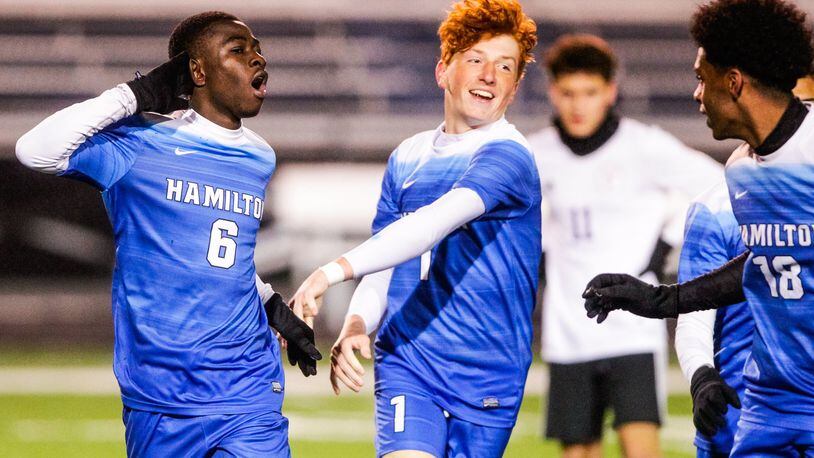 Hamilton’s Kelvin Effah (6) celebrates a goal with teammate Cole Hamilton during their 4-2 Division I sectional win over visiting Middletown on Monday night at Virgil Schwarm Stadium in Hamilton. NICK GRAHAM/STAFF