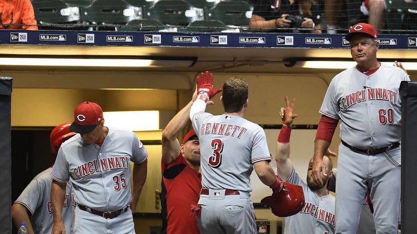 MILWAUKEE, WI - AUGUST 21:  Scooter Gennett #3 of the Cincinnati Reds is congratulated by teammates following a home run during the ninth inning of a game against the Milwaukee Brewers at Miller Park on August 21, 2018 in Milwaukee, Wisconsin.  (Photo by Stacy Revere/Getty Images)