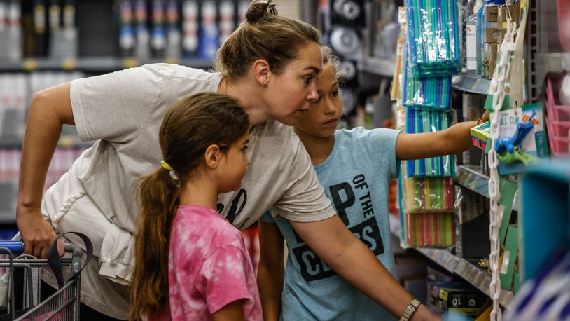 Natalie Folino and her two daughters, Bianca, left and Genevieve on the right shop for back to school supplies at the Super Walmart on Wilmington Pike .Ohio’s sales tax holiday on school supplies, instructional material and clothes runs from noon Aug. 5 to 11:59 p.m. Aug. 7. Exempt from sales and use tax during the holiday are items of clothing priced at $75 or less, items of school supplies priced at $20 or less and items of school instructional material priced at $20 or less.  JIM NOELKER/STAFF