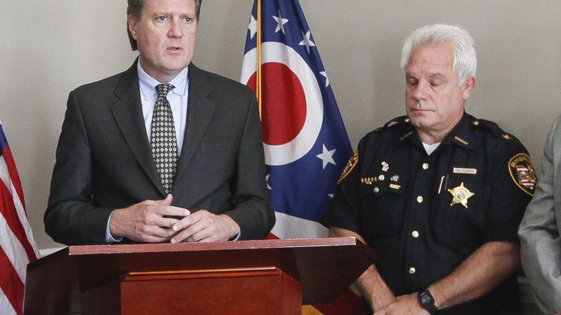 U.S. Rep Mike Turner (left), R-Dayton, and Montgomery County Sheriff Phil Plummer called for the selection of an area “drug czar” to lead and coordinate the local response to the opioid crisis. CHRIS STEWART / STAFF