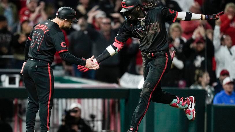 Cincinnati Reds' Elly De La Cruz, right, celebrates with third base coach Collin Cowgill as he rounds the bases after hitting a three-run home run in the eighth inning of a baseball game against the Los Angeles Angels, Friday, April 19, 2024, in Cincinnati. (AP Photo/Carolyn Kaster)