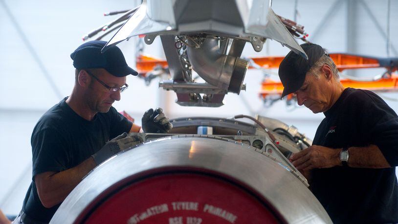 A file photo of workers with a CFM56 engine built by CFM International. The engine was being readied for installation on the A320 final assembly line at a Airbus factory. FILE