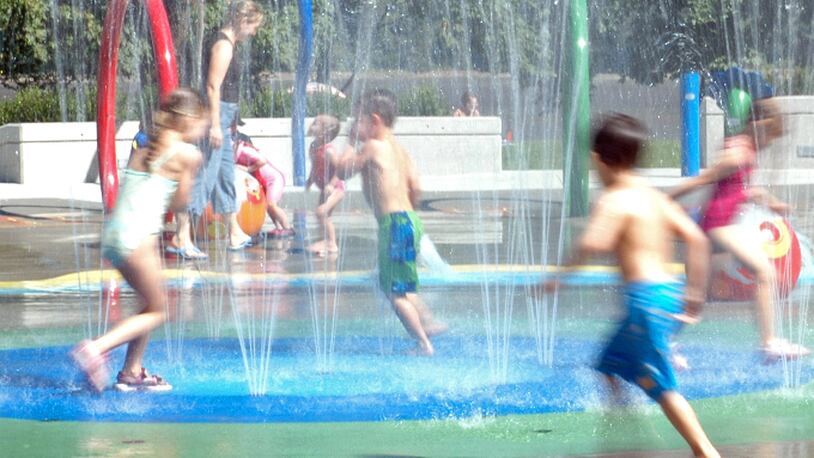 Kids playing in fountain (stock photo).