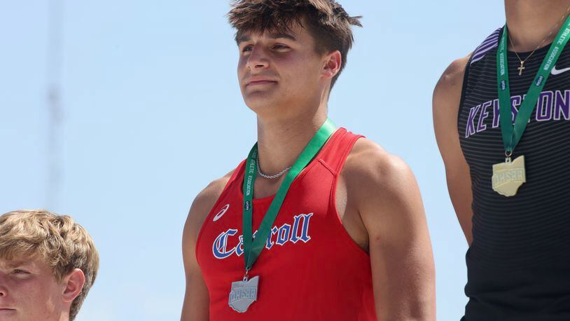 Sammy Deep, of Carroll, stands on the podium after finishing second in the long jump at the Division II state track meet on Friday, June 2, 2023, at Jesse Owens Memorial Stadium  in Columbus. David Jablonski/Staff
