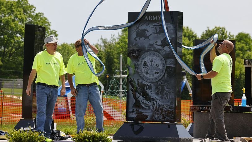 A crew from Art & Stone Monument Company installs a monument of the Fairfield Twp. Veterans Memorial at Heroes Park. A dedication of the completed memorial will be held at 1 p.m. on June 3. NICK GRAHAM/STAFF