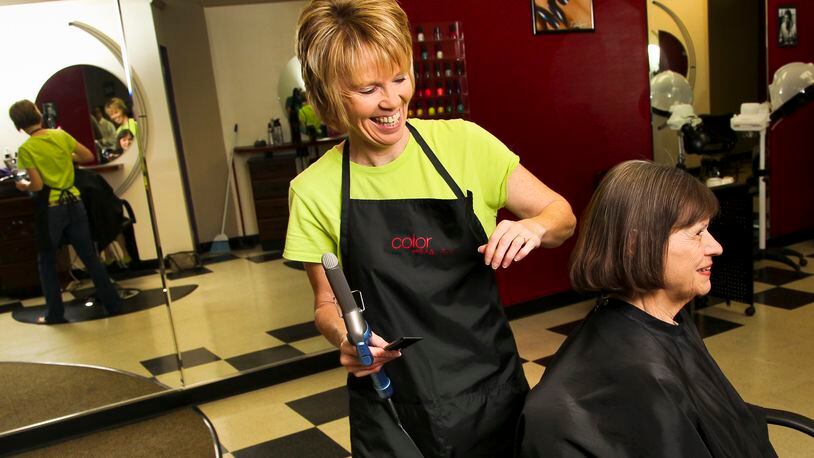 Lynne Tufts, stylist and co-owner of Tufts of Hair, finishes Janet Chase’s haircut and style Tuesday, June 12, 2012, at the shop along Central Avenue in Middletown, Ohio. Staff photo by Nick Daggy