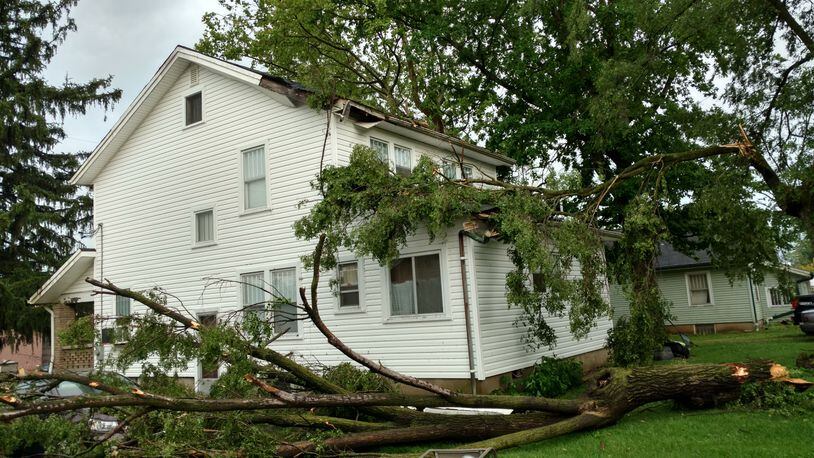 This tree slammed into this house and car (far left) on Union Road in Moraine during the storm that hit the region on Friday afternoon, May 19, 2017. (Courtesy/Ron Boehringer)