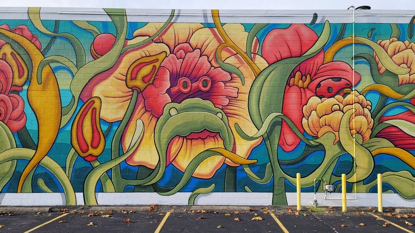 This 3,400 square-foot mural, entitled "Garden of Dogs," recently was completed on the side of the ELITE Performance and Wellness building, 190 N. Brookwood Ave. The mural cost about $50,000. NICK GRAHAM/STAFF