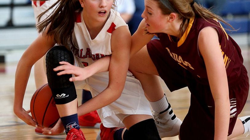 Talawanda guard Addie Brown (left) tries to keep a loose ball away from Karlie Becker of Ross during their game at Talawanda on Feb. 6, 2016. COX MEDIA FILE PHOTO