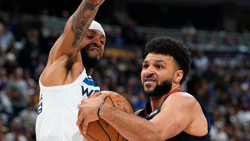 Denver Nuggets guard Jamal Murray, right, drives to the basket as Minnesota Timberwolves guard Nickeil Alexander-Walker, left, defends in the first half of Game 2 of an NBA basketball second-round playoff series Monday, May 6, 2024, in Denver. (AP Photo/David Zalubowski)