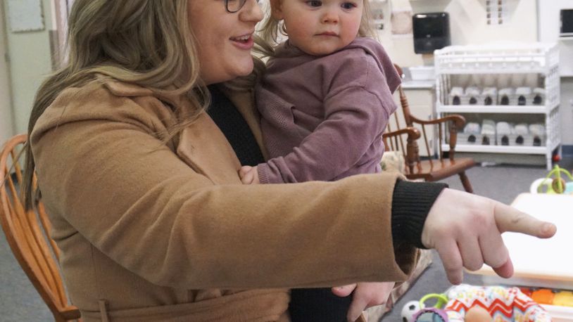 Christina Zimmerman, who teaches fourth grade at Endeavor Elementary, drops off her daughter Parker, 1, at the school's onsite daycare on Feb. 29, 2024, in Nampa, Idaho. (Carly Flandro/Idaho Education News via AP)