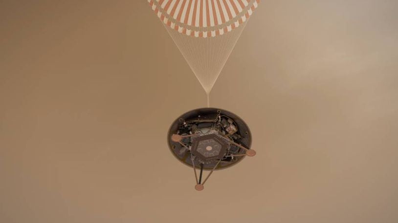 This illustration shows a simulated view of NASA's InSight lander descending towards the surface of Mars on its parachute.