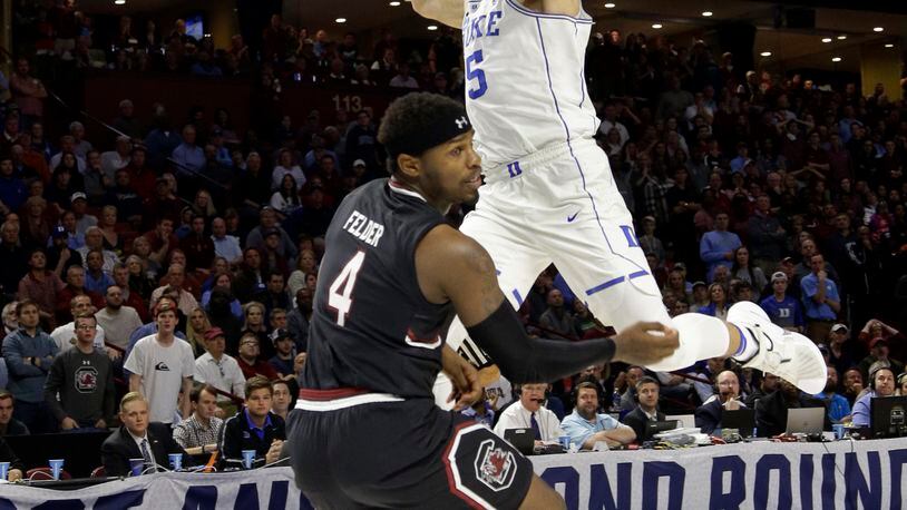 Duke’s Luke Kennard (5) is fouled by South Carolina’s Rakym Felder (4) during the second half in a second-round game of the NCAA men’s college basketball tournament in Greenville, S.C., Sunday, March 19, 2017. (AP Photo/Chuck Burton)