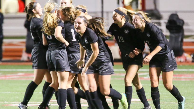 Lakota East celebrates a goal by Abby Stoughton during Tuesday night’s Division I sectional girls soccer final against Loveland at Lakota West. GREG LYNCH/STAFF