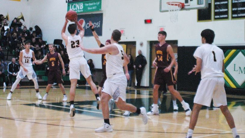 Little Miami’s Cole Spencer (23) puts up a shot over the Ross defense, which includes Max Stepaniak (34), during Friday night’s game at Little Miami. The host Panthers won 52-51. RICK CASSANO/STAFF