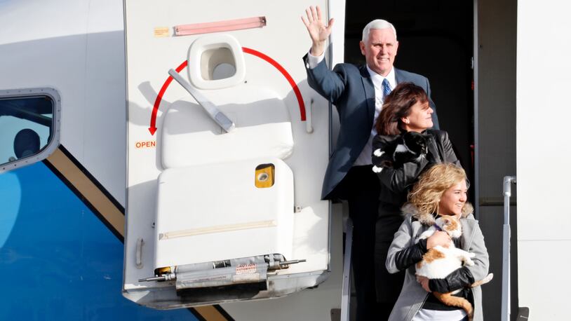 Then Vice President-elect Mike Pence steps off an Air Force plane with his wife Karen Pence, center, holding cat "Oreo," and daughter Charlotte Pence holding "Pickle," arrive at Andrews Air Force Base, Md., Monday, Jan. 9, 2017. (AP Photo/Alex Brandon)