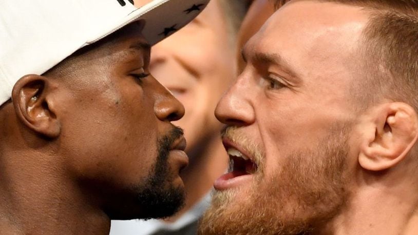 Boxer Floyd Mayweather Jr. (left) and UFC lightweight champion Conor McGregor face off during their official weigh-in at T-Mobile Arena.
