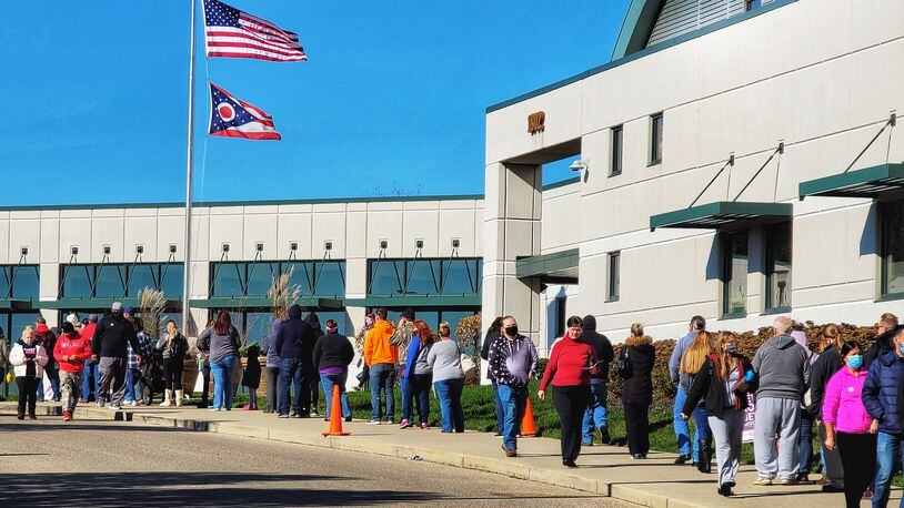 A long line forms in front of the Butler County Board of Elections on the last day of early voting Monday, Nov. 2, 2020 in Hamilton. NICK GRAHAM / STAFF