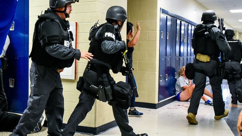 Hamilton Police Department, Hamilton Fire department and other local agencies participated in a SWAT Training drill in June with Hamilton City School District at Hamilton High School. NICK GRAHAM/STAFF